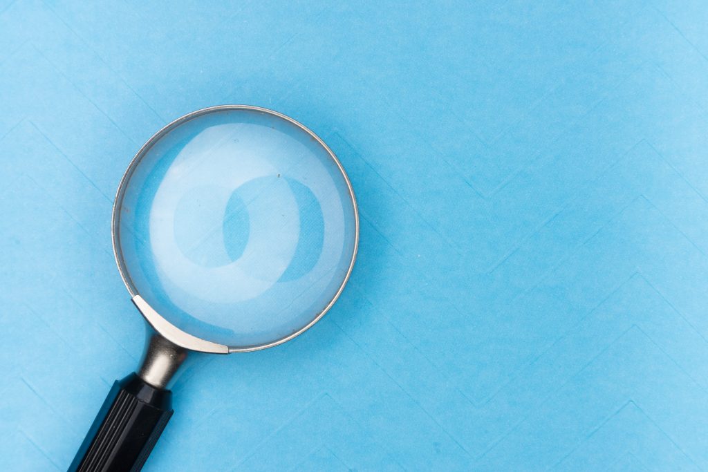 A magnifying glass against a blue background