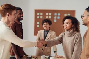 People in a room shaking hands